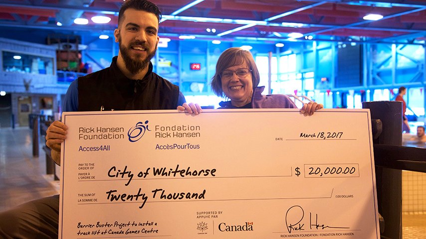 Canada Games Centre's management staff shows the cheque from Barrier Buster grant